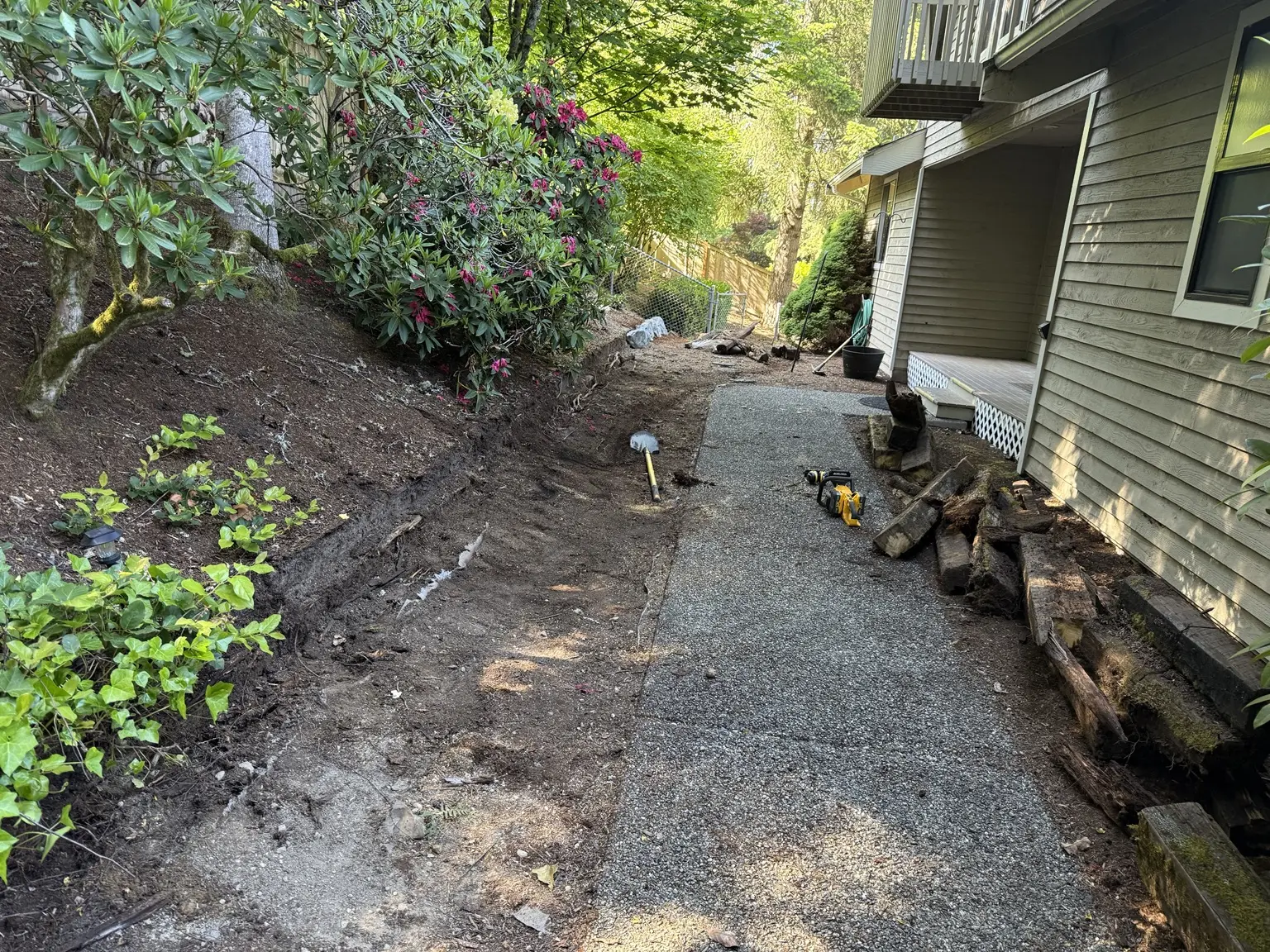 Entrance work area cleared after deteriorated landscape timbers were removed