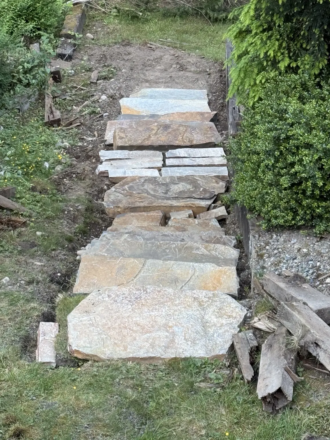 Large natural stone treads dry-set along the hillside route